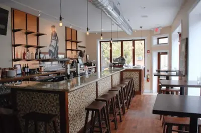 a restaurant with a bar with tables and chairs at Modern Cozy Huge Balcony in Heart of Passyunk in Philadelphia