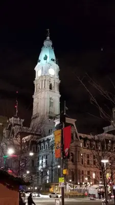a large building with a clock tower at night at Modern Cozy Huge Balcony in Heart of Passyunk in Philadelphia
