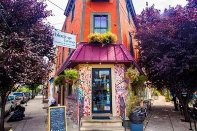 a shop with a purple awning on a city street at Modern Cozy Huge Balcony in Heart of Passyunk in Philadelphia
