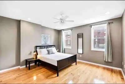 a bedroom with a bed and a ceiling fan at Modern Cozy Huge Balcony in Heart of Passyunk in Philadelphia
