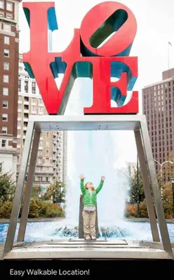 a man standing in front of a large sign at Luxe City Hall Suite by Rittenhouse Square in Philadelphia