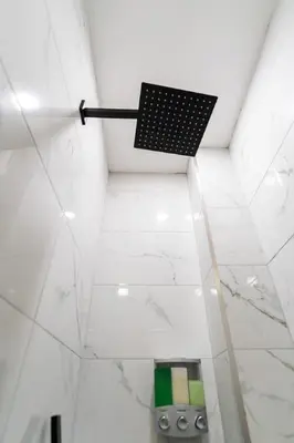a shower in a bathroom with a black at New - Suite by Rittenhouse Square in Philadelphia