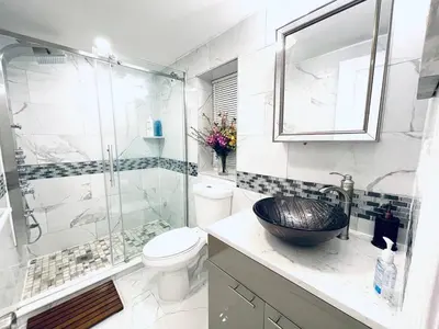 a bathroom with a sink and a shower and a toilet at Downtown City Hall near Kimmel Center 2BD Suite in Philadelphia