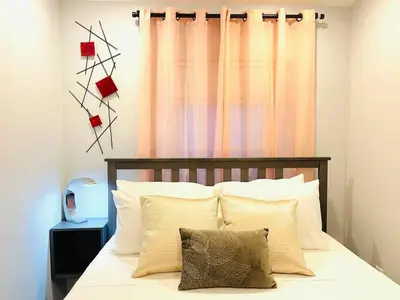 a bedroom with a bed with white pillows and a window at Downtown City Hall near Kimmel Center 2BD Suite in Philadelphia