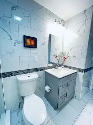 a white bathroom with a toilet and a sink at Downtown City Hall close by Kimmel Center 1BD in Philadelphia