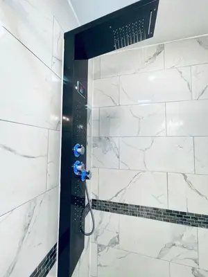 a bathroom with a shower with white marble at Downtown City Hall close by Kimmel Center 1BD in Philadelphia