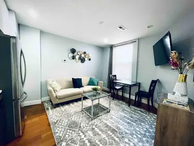 a living room with a couch and a table at Downtown City Hall close by Kimmel Center 1BD in Philadelphia