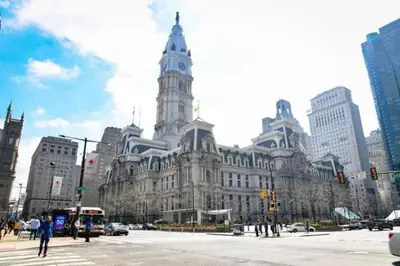 a large building with a clock tower in a city at Downtown City Hall close by Kimmel Center 1BD in Philadelphia