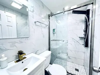 a white bathroom with a sink and a shower at New - Suite nearby Rittenhouse Square in Philadelphia