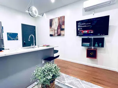 a kitchen with a sink and a tv on the wall at NEW - 1 Bedroom near Rittenhouse Square in Philadelphia