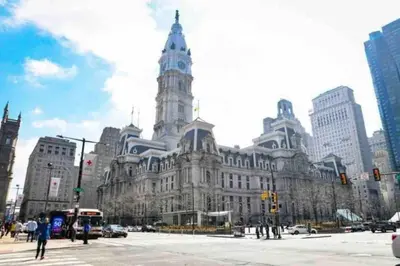 a large building with a clock tower in a city at NEW - 1 Bedroom near Rittenhouse Square in Philadelphia