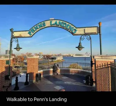 a sign for a pier with two people walking under a street light at NEW - 1 Bedroom near Rittenhouse Square in Philadelphia