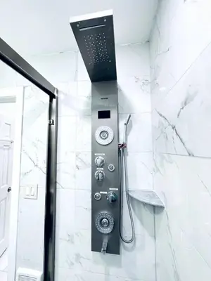 a shower in a bathroom with white marble walls at NEW - 1 Bedroom close by Rittenhouse Square in Philadelphia