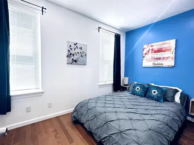 a bedroom with blue walls and a bed with blue pillows at NEW - 1 Bedroom close by Rittenhouse Square in Philadelphia