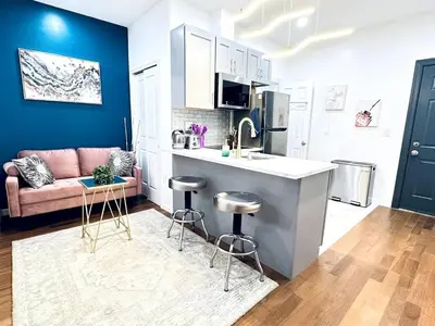 a kitchen and living room with a couch and a counter at NEW - 1 Bedroom close by Rittenhouse Square in Philadelphia
