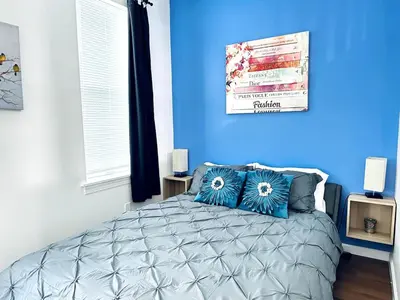 a blue bedroom with a bed with blue walls at NEW - 1 Bedroom close by Rittenhouse Square in Philadelphia