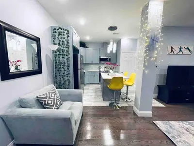 a living room with a couch and a kitchen at Stunning 1Bedroom Apartment in Center City in Philadelphia