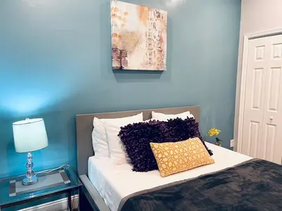a bed with two pillows on it in a bedroom at Magic Gardens 2BD Apt in Center City in Philadelphia