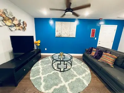 a living room with a couch and a table at Magic Gardens 2BD Apt in Center City in Philadelphia