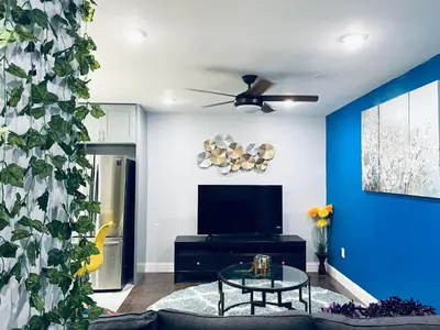 a living room with a couch and a tv at Magic Gardens 2BD Apt in Center City in Philadelphia