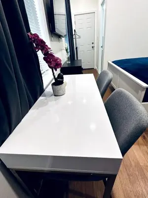 a white table with two chairs and a plant on it at New - Suite close by Rittenhouse Square in Philadelphia