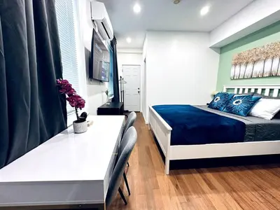 a bedroom with a blue and white bed and a table at New - Suite close by Rittenhouse Square in Philadelphia