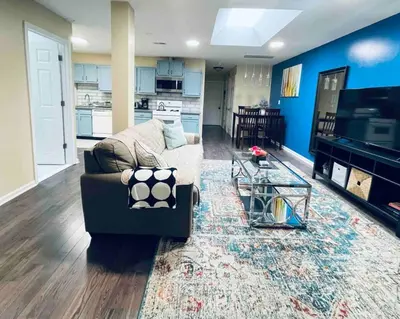 a living room with a couch and a television at Lovely 1BD Apt Near Magic Garden in Center City in Philadelphia