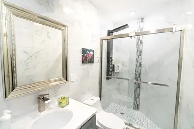 a bathroom with a shower and a toilet and a sink at Rittenhouse Square near Kimmel Center 1BD in Philadelphia