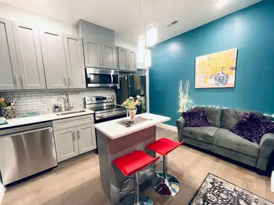 a kitchen and living room with a couch and a table at Rittenhouse Square near Kimmel Center 1BD in Philadelphia