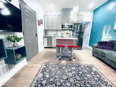 a living room with a kitchen with a table and a couch at Rittenhouse Square near Kimmel Center 1BD in Philadelphia
