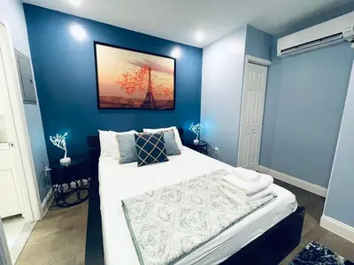 a bedroom with blue walls and a large bed at Rittenhouse Square near Kimmel Center Studio Suite in Philadelphia