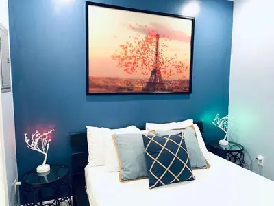 a bedroom with a bed and a picture of the eiffel tower at Rittenhouse Square near Kimmel Center Studio Suite in Philadelphia