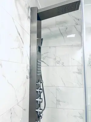 a shower in a bathroom with white marble at Rittenhouse Square near Kimmel Center Studio Suite in Philadelphia