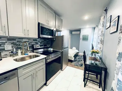 a kitchen with a sink and a refrigerator at Rittenhouse Square near Kimmel Center Studio Suite in Philadelphia