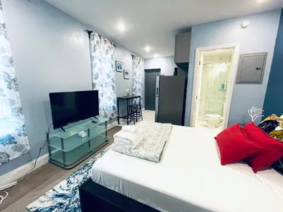 a bedroom with a bed and a flat screen tv at Rittenhouse Square near Kimmel Center Studio Suite in Philadelphia