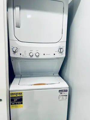 a white refrigerator freezer with avertisement for at Vibrant 1BD Suite in Downtown Center City in Philadelphia