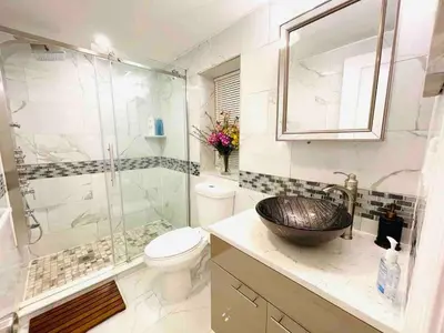 a bathroom with a sink and a toilet and a shower at Vibrant 1BD Suite in Downtown Center City in Philadelphia
