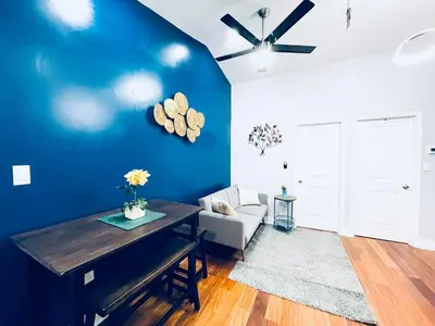 a living room with a blue wall and a ceiling fan at Vibrant 1BD Suite in Downtown Center City in Philadelphia