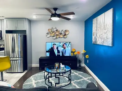 a living room with blue walls and a ceiling fan at Magic Gardens 1BD Apt in Center City in Philadelphia