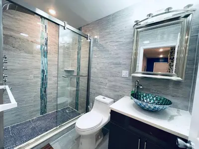 a bathroom with a shower and a toilet and a sink at Magic Gardens 1BD Apt in Center City in Philadelphia