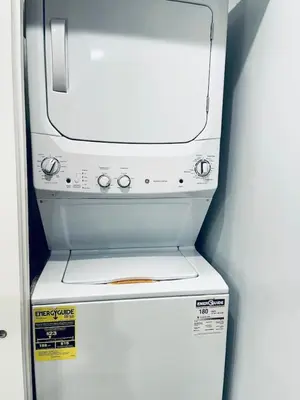 a white refrigerator with a stove top oven at Magic Gardens 1BD Apt in Center City in Philadelphia