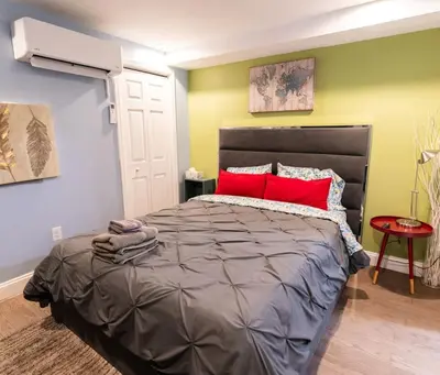 a bedroom with a large bed with red pillows at Rittenhouse Square near Kimmel Center Studio in Philadelphia