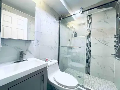 a bathroom with a toilet and a glass shower at Rittenhouse Square near Kimmel Center Studio in Philadelphia