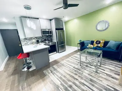 a kitchen and living room with a couch and a table at Rittenhouse Square near Kimmel Center 1BD Suite in Philadelphia