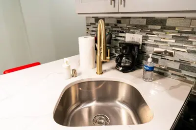 a kitchen counter with a sink and a coffee maker at Rittenhouse Square near Kimmel Center 1BD Suite in Philadelphia