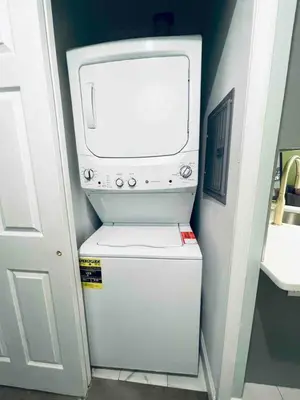 a television sitting on top of a small refrigerator at Rittenhouse Square near Kimmel Center 1BD Suite in Philadelphia