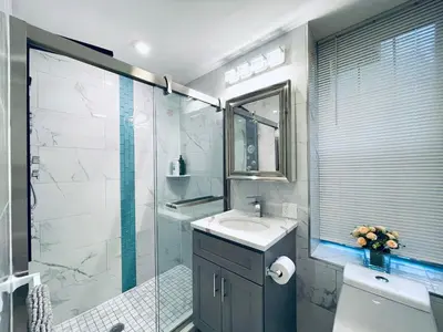 a bathroom with a sink and a glass shower at Rittenhouse Square near Kimmel Center 1BD Suite in Philadelphia
