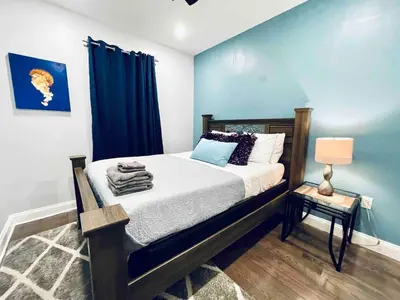 a bedroom with a bed with a blue wall at Lovely Beautiful 2BR Apt in Center City in Philadelphia