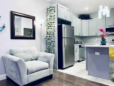 a kitchen with a chair and a refrigerator at Lovely Beautiful 2BR Apt in Center City in Philadelphia