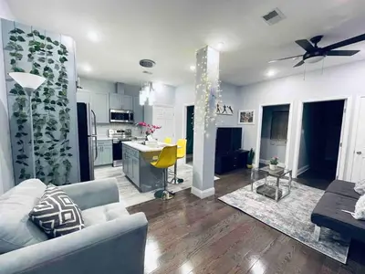 a living room with a couch and a kitchen at Lovely Beautiful 2BR Apt in Center City in Philadelphia